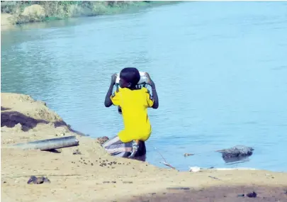  ?? PHOTO: SANI MAIKATANGA ?? A boy fetching water from a river at Tiga village in Kano recently.