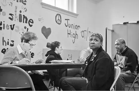  ??  ?? Munoz, second from right, works with I.D. ministry volunteer Linda Flick at Foundry United Methodist Church in Washington, D.C.