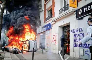  ?? REUTERS ?? A car burns outside a Renault automobile garage during clashes at the May Day labour union march in Paris, France, on Tuesday. Masked protesters from the far-left anarchist group, the Black Blocs, hijacked what was intended to be a peaceful rally...