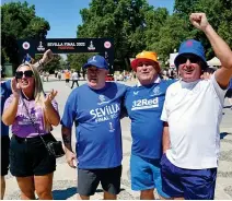  ?? ?? Spanish ayes: Fans get the party started in Seville, where hats, shades and cold drinks helped beat the heat