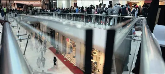  ?? PHOTO: AP ?? Shoppers make their way along the broad shopping walk-ways in the newly-opened Mall of Africa in Midrand yesterday.