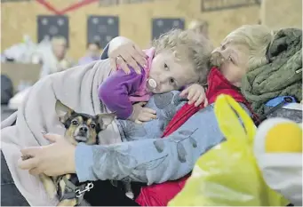  ?? ?? One of the many images of traumatise­d mothers, children and pets sheltering from the horrors of war