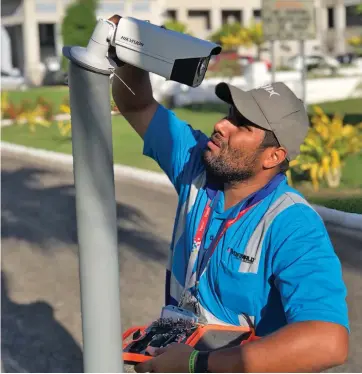  ??  ?? Wormald Fire and Security staff installing CCTV camera at the Government building compound in Suva.