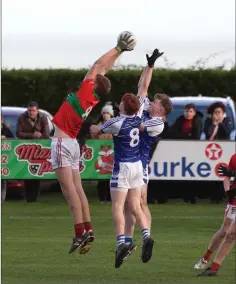  ??  ?? Rathnew’s Ciaran Coffey plucks a high ball out of the sky.