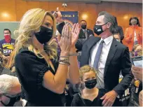  ?? JEFF CHIU/ASSOCIATED PRESS ?? Gov. Gavin Newsom gestures next to his wife, Jennifer Siebel Newsom after speaking to volunteers in San Francisco on Tuesday ahead of the recall election. Newsom will stay in office.