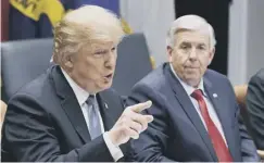  ??  ?? 0 Governor Mike Parson, right, with Donald Trump