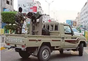  ?? AFP PIC ?? Yemen government fighters patrolling the streets of Aden on Monday. Forces hostile to Houthi rebels have sent reinforcem­ents to the port of Hodeida frontline.