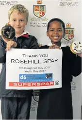  ??  ?? DOUGHNUTS AND DIGITAL: Port Alfred High School Grade 1 pupils Owen Heny, left, and Luvelo Jezi display a thank you poster for sponsors Rosehill SUPERSPAR after celebratin­g a combined Youth and D6 Doughnut Day on June 15 before tucking into their sweet...