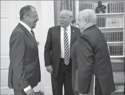  ?? The Associated Press ?? DIPLOMATIC MEETING: U.S. President Donald Trump meets with Russian Foreign Minister Sergey Lavrov, left, next to Russian Ambassador to the U.S. Sergei Kislyak on Wednesday at the White House in Washington. Trump on Wednesday welcomed Vladimir Putin's...