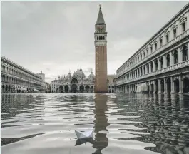  ??  ?? A paper boat bobbing in St Mark’s Square in Venice last week AP