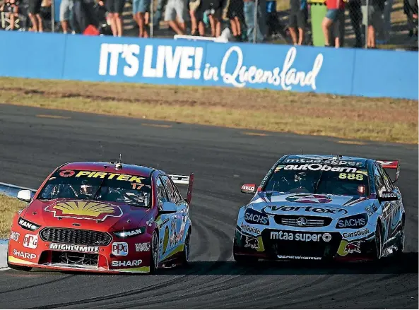  ??  ?? Scott McLaughlin takes an inside line to pass Craig Lowndes during the opening race of the Ipswich Supersprin­t yesterday.