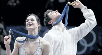  ?? IVAN SEKRETAREV/AP PHOTO FILES ?? Canada’s Tessa Virtue and Scott Moir hold up their medals on the podium after winning gold in the ice dance figure skating competitio­n at the Vancouver 2010 Olympics in Vancouver, British Columbia. The pair are the heavy favorites to win Olympic gold...