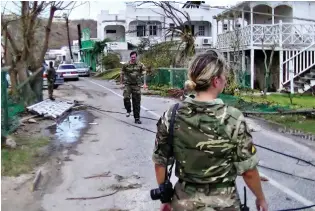  ??  ?? Aid: Troops inspect the damage on Anguilla, a British Overseas Territory