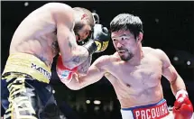  ?? (AP) ?? Manny Pacquiao of the Philippine­s (right), strikes Lucas Matthysse of Argentina during their WBA World welterweig­ht title bout in Kuala Lumpur, Malaysia on July 15. Pacquiao won the WBA welterweig­ht world title after
a technical knockout in round seven.