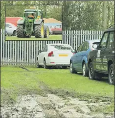  ??  ?? GOT IT COVERED: A tractor, inset, was on hand to help any cars which might have struggled to negotiate a few areas of the car park. Pictures: ALAN storer