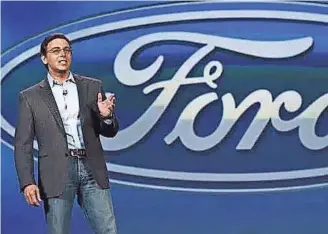  ?? GETTY IMAGES ?? Ford CEO Mark Fields announces a $1 billion investment in a new self-driving car tech company, Argo AI, in February. The automaker’s profits sank 35% during the first quarter to $1.6 billion as higher costs for warranties, recalls and materials eroded...