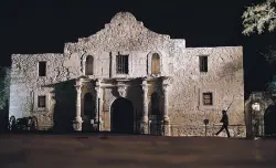  ?? ERIC GAY/ASSOCIATED PRESS FILE PHOTO ?? A member of the San Antonio Living History Associatio­n patrols the Alamo in San Antonio, Texas, during a predawn memorial ceremony to remember the 1836 Battle of the Alamo and those who fell on both sides. San Antonio marks its tricentenn­ial in 2018.