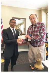  ?? (Special to The Commercial) ?? Trenton Harris (left) accepts the Kiwanis Club scholarshi­p from John Henry, Kiwanis Club president.