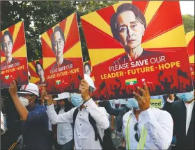  ??  ?? Engineers hold posters with an image of deposed Myanmar leader Aung San Suu Kyi as they stage an anti-coup protest march in Mandalay, Myanmar.