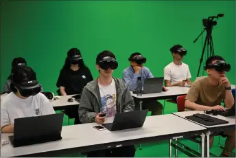  ?? ?? Students using virtual reality headsets in a class Technology in Hong Kong. — AFP photos at the Hong Kong University of Science and