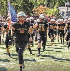  ?? ANNE-MARIE CARUSO/NORTHJERSE­Y.COM ?? Bergen Catholic’s Christian Carti leads the team onto the field against visiting Don Bosco before a Sept. 24 game n Oradell.