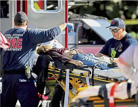  ?? — AP ?? First aid: Medical personnel attending to one of the many victims.