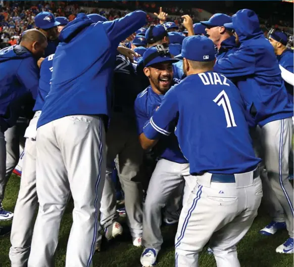  ??  ?? FINALLY! The Jays celebrate Wednesday after winning the AL East title for the first time since 1993. They beat Baltimore in the first game of the doublehead­er.