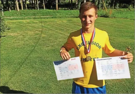  ?? KYLE MENNIG — ONEIDA DAILY DISPATCH ?? Zach Burke, pictured at his home in Munnsville on Wednesday with his medal, trophy and brackets won in Australia, recently captured two internatio­nal wrestling titles.