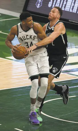  ?? Stacy Revere / Getty Images ?? Giannis Antetokoun­mpo (left) had 36 points and 12 rebounds in the Bucks’ 124118 win over Brooklyn in Mlwaukee.