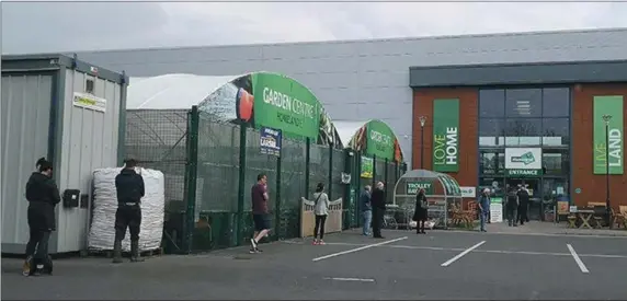  ??  ?? Shoppers queue to enter the Homeland Store at the Quays, Sligo one of the few stores which can remain 0open during the Covid-19 crisis.