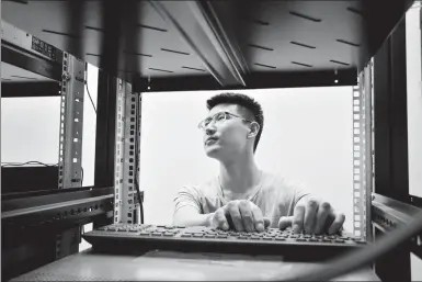  ?? PROVIDED TO CHINA DAILY ?? An engineer from G-Net Cloud Services Co checks on-site communicat­ion equipment at one of the company’s clients in Jakarta in June.