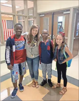  ??  ?? Students at Rockmart Middle stopped for a photo at the front doors on their first morning back to school on Friday, August 2.