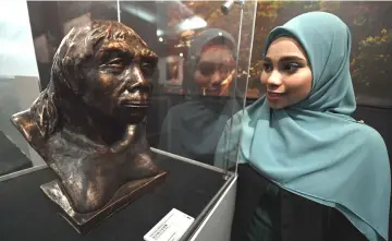  ??  ?? University Kuala Lumpur student Sarah Syuhada visits Peking Man Exhibition — Zhoukoudia­n Heritage Site at the Museum Negara. — Bernama photo