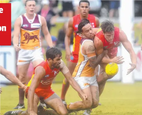  ??  ?? SOGGY: Brisbane’s Allen Christense­n tackles Gold Coast’s David Swallow at Southport yesterday. Picture: GETTY IMAGES