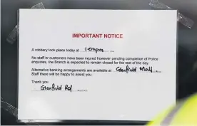  ?? Picture / Dean Purcell ?? Police (top) at the ANZ Bank in Glenfield after the hold-up yesterday. A notice tells customers the bank is closed for the rest of the day.