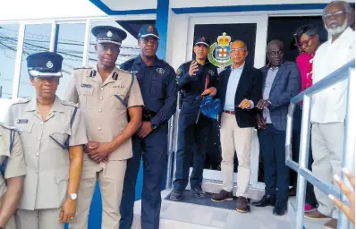  ?? PHOTO BY BRYAN MILLER ?? Minister of National Security Dr Horace Chang (fourth right), assists Major General Antony Anderson (fifth right), the outgoing commission­er of police, in cutting the ribbon to mark the official opening of the Hopewell Police Station in Hanover. Sharing in the moment are (from left) Superinten­dent Sharon Beeput; Assistant Commission­er in charge of Area 1 Clifford Chambers; Deputy Commission­er Dr Kevin Blake; Mayor of Lucea Sheridan Samuels; Deputy Mayor of Lucea Andria Dehaney-Grant; and Custos of Hanover Dr David Stair.