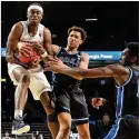  ?? HYOSUB SHIN/HYOSUB.SHIN@AJC.COM ?? Georgia Tech’s Michael Devoe grabs one of his seven rebounds Tuesday night over Duke’s Wendell Moore Jr. in Atlanta. Tech won the game 81-77 in OT.