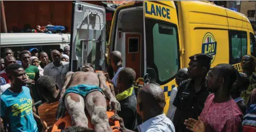  ??  ?? A victim rescued at the scene of building collapse at Daddy Alaja Street, Oke Arin on Lagos Island... recently