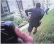  ??  ?? In a still image from a police officer body camera, Sylville Smith is seen falling to the ground with a gun leaving his hand as officers Dominique Heaggan-Brown and Nvida Malafa pursue.