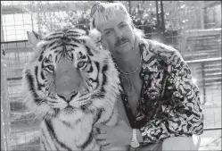  ?? TRIBUNE NEWS SERVICE/NETFLIX ?? Joe Exotic poses with one of his wild cats in "Tiger King."