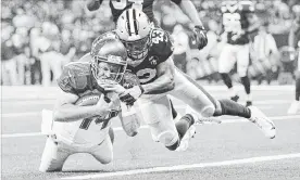  ?? WESLEY HITT GETTY IMAGES ?? Ryan Fitzpatric­k of the Tampa Bay Buccaneers runs the ball for a touchdown as Marcus Williams of the Saints tries to tackle him Sunday in New Orleans. The Bucs won, 48-40.