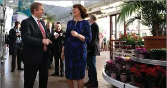  ??  ?? Taoiseach Enda Kenny talks with Ballyseedy Garden Centre Managing Director Bernie Falvey at the launch of the Enet fibre broadband scheme at the centre on Friday. Photo Eye Focus.