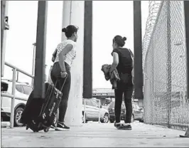  ?? ERIC GAY/AP ?? Sisters from Guatemala seeking asylum cross a bridge from Matamoros, Mexico, to a U.S. port of entry in Brownsvill­e, Texas. Asylum seekers now face a more restricted process.