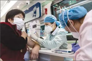  ?? GETTY IMAGES ?? A resident receives COVID-19 vaccinatio­n in a mobile medical station in Wuhan, China, on March 25.