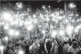  ?? Associated Press file ?? Hundreds of protesters hold their phones aloft during a racial justice rally in July in Portland, Ore. The city has reached a stunning benchmark: 100 consecutiv­e nights of protests, many marred by violence.