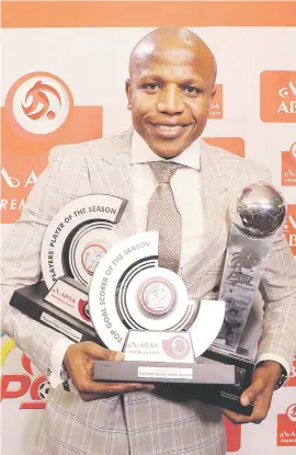  ?? Picture: Backpagepi­x ?? BLING COLLECTOR. Lebogang Manyama of Cape Town City poses with his loot after cleaning up at the PSL Awards in Sandton on Monday night.