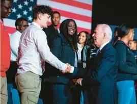  ?? AL DRAGO/THE NEW YORK TIMES ?? President Joe Biden meets with students after speaking about his student loan forgivenes­s plan Friday at Delaware State University in Dover, Delaware.