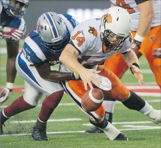  ?? — CP PHOTO ?? Montreal Alouettes’ Mike Edem, left, sacks B.C. Lions quarterbac­k Travis Lulay during the first half of Thursday’s game in Montreal. ‘We’re making strides here and there but we make enough mistakes to hold us back,” Lulay says of the struggling Lions.