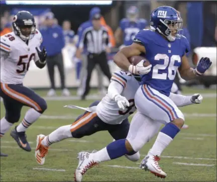  ?? SETH WENIG - THE ASSOCIATED PRESS ?? New York Giants running back Saquon Barkley (26) runs with the ball as Chicago Bears free safety Eddie Jackson (39) moves in to make the tackle during the second half of an NFL football game, Sunday, Dec. 2, 2018, in East Rutherford, N.J.