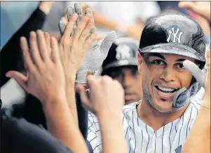  ?? AP PHOTO ?? New York Yankees star Giancarlo Stanton is one of a growing number of MLB stars to adopt the protective face guard on their batting helmet.